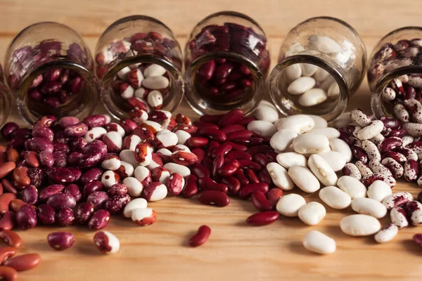Multi Colored Beans Poured Out Jars Table White Red Colored — Stock Photo, Image