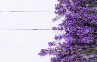 Fragrant lavender flowers on a white wooden background. Place for text