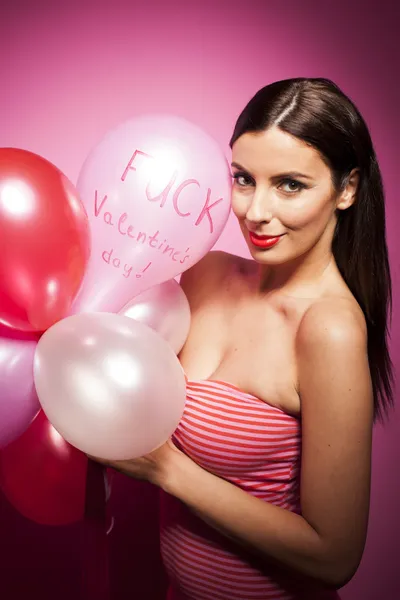 Beautiful woman with valentines day decorations on pink background — Stock Photo, Image