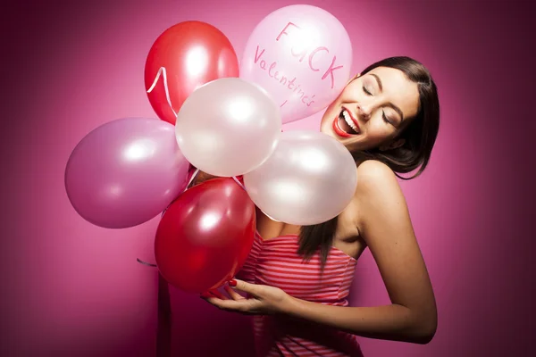 Beautiful woman with valentines day decorations on pink background — Stock Photo, Image