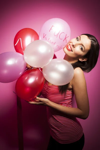 Beautiful woman with valentines day decorations on pink background — Stock Photo, Image