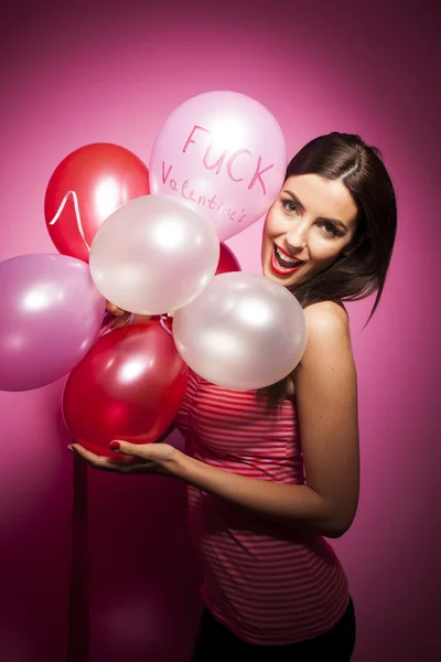 Beautiful woman with valentines day decorations on pink background — Stock Photo, Image