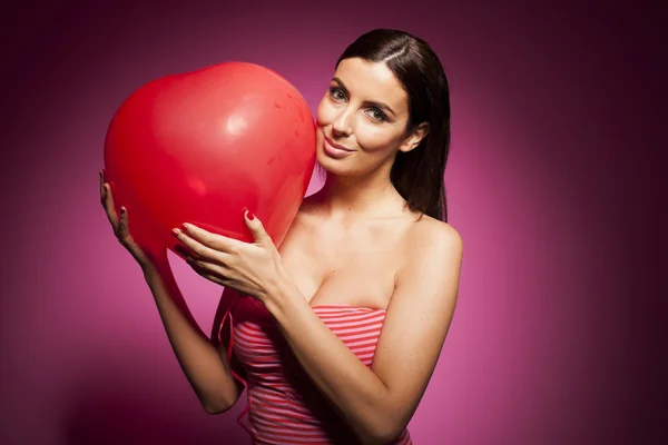 Beautiful woman with valentines day decorations on pink background — Stock Photo, Image