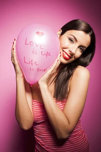 Beautiful woman with valentines day decorations on pink background — Stock Photo, Image