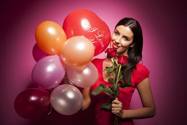 Beautiful woman with valentines day decorations on pink background — Stock Photo, Image