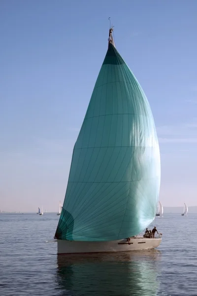 Sailboat with green spinnaker — Stock Photo, Image