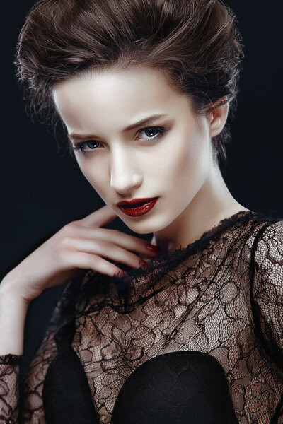 Beauty Woman with Perfect Makeup. Beautiful Professional Holiday Make-up. Red Lips and Nails. Beauty Girl's Face.