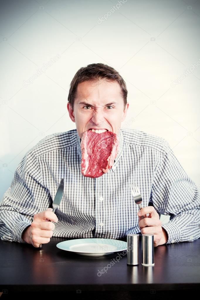 Young adult men eating raw meat, toned image, add grain