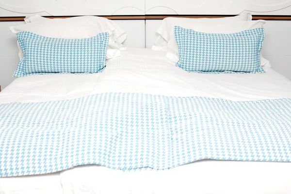 Imagem de uma cama com travesseiro azul no quarto do hotel — Fotografia de Stock