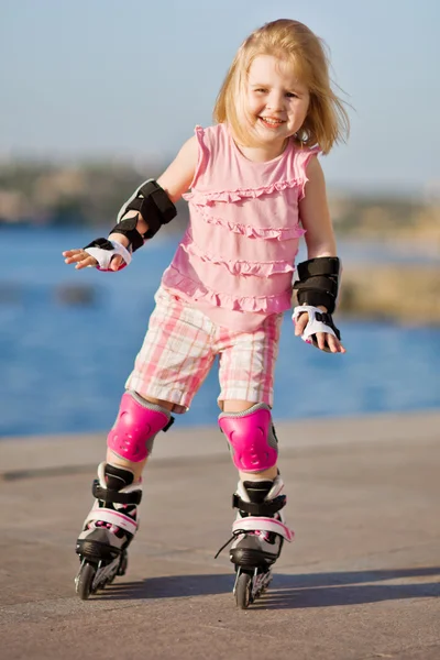 Little pretty girl riding a roller Royalty Free Stock Images