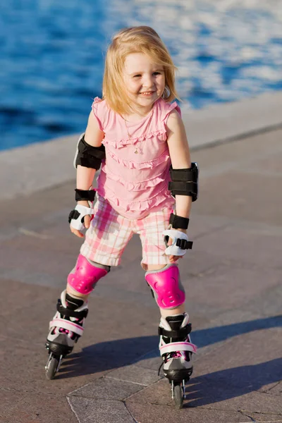 Little pretty girl riding a roller Stock Image