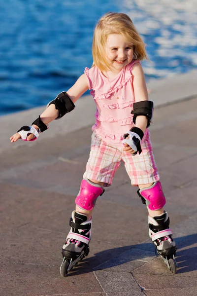 Little pretty girl riding a roller Royalty Free Stock Photos