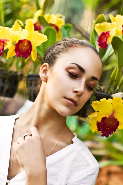 Young beautiful woman with yellow wreath of orchids — Stock Photo, Image