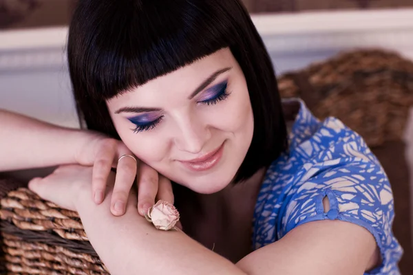 Closeup portrait of a girl in a brown chair — Stock Photo, Image