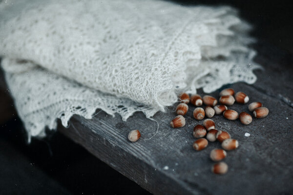 Scarf and nuts on the wood
