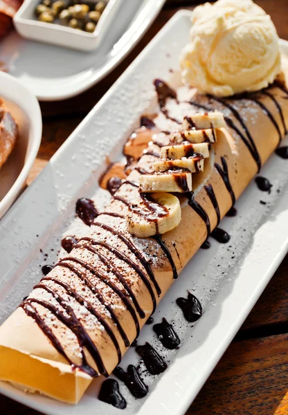 Crepe with bananas and ice cream on white plate — Stock Photo, Image