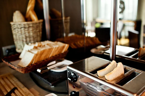 Assortment of fresh pastry on table in buffet with toaster — Stock Photo, Image