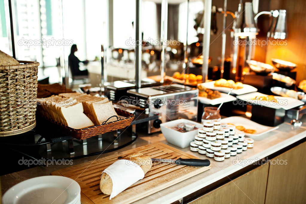 Assortment of fresh pastry on table in buffet with toaster