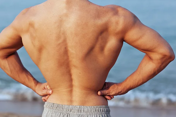 Attractive man back on the beach — Stock Photo, Image