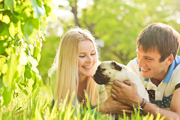 Coppia carina divertirsi con il loro cane al parco — Foto Stock