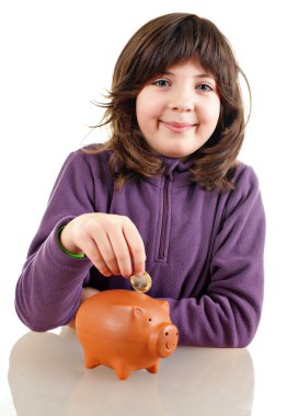 Girl saving money in a piggy bank