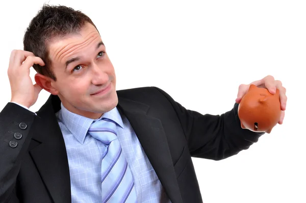 iş adamı izole bir kumbara bakan