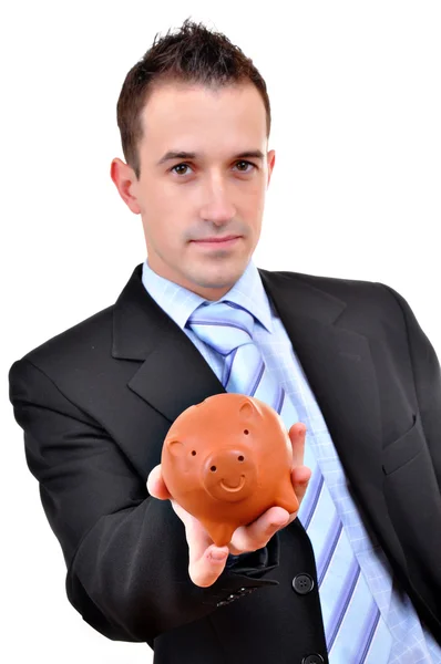 Um empresário atraente a segurar o Piggy Bank. Tudo sobre fundo branco — Fotografia de Stock
