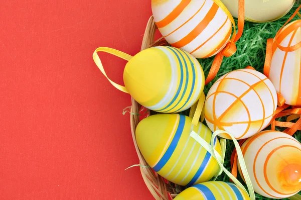 Colorful Easter Eggs basket set on red background — Stock Photo, Image