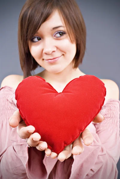 Giovane donna sorridente felice con simbolo del cuore, isolata — Foto Stock