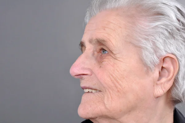 Old, attractive Caucasian woman looking off into the distance.