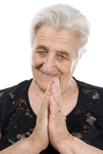 Old, attractive Caucasian woman praying — Stock Photo, Image