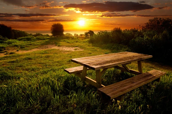 Park bench at sunset — Stock Photo, Image