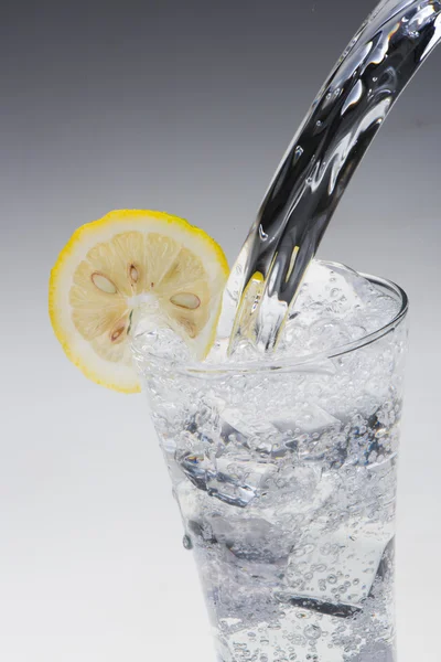 Pouring water into glass — Stock Photo, Image