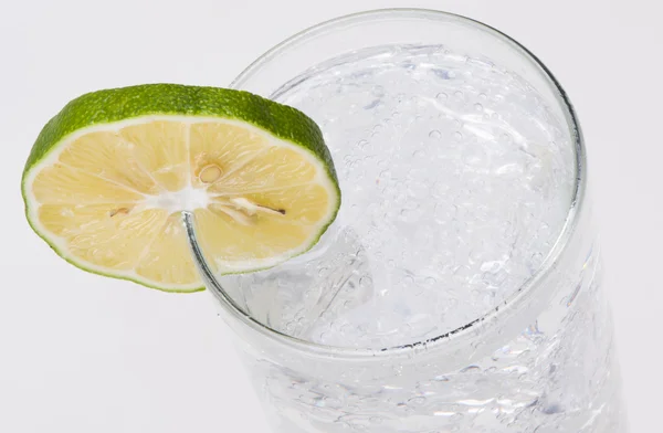 A glass of water with lime — Stock Photo, Image