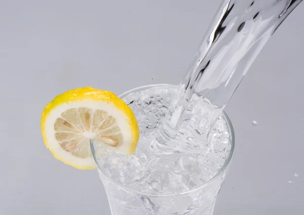 Pouring water into glass — Stock Photo, Image