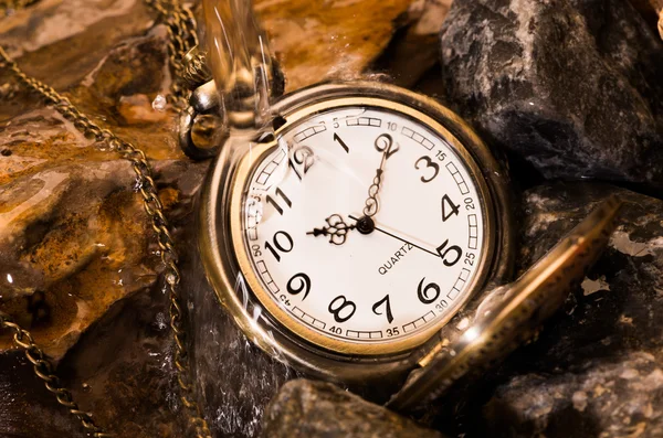 Pocket watch with rock — Stock Photo, Image