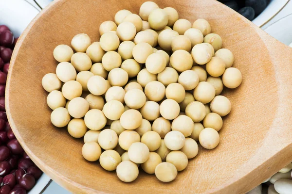 Soya in wooden tablespoon — Stock Photo, Image