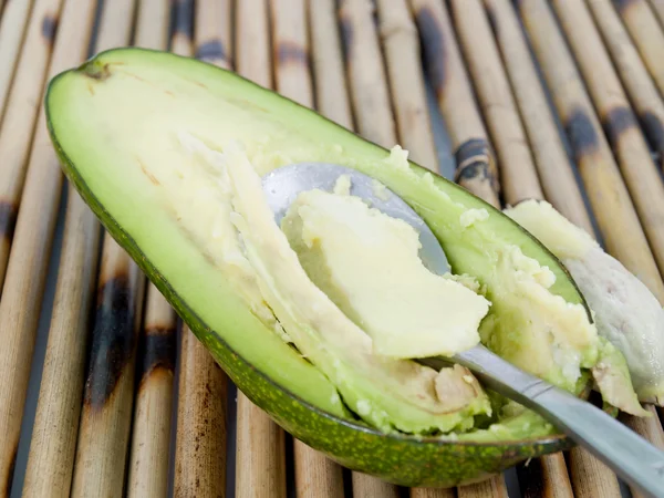 Spoon gather avocado — Stock Photo, Image