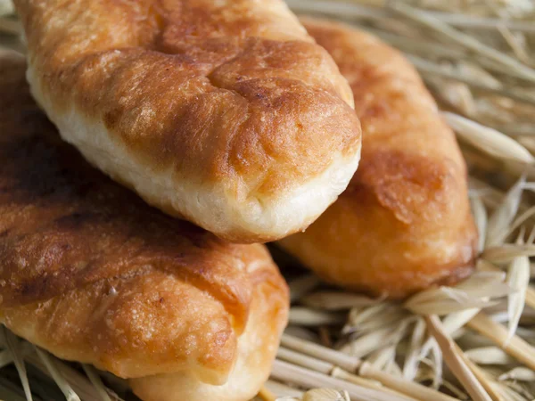 Three pies on a heap of straw — Stock Photo, Image