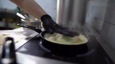 Sarı bir krep ya kızarır ya da yağda yakın plan bir tavada pişirilir ve buharı boşaltır, şefin elleri onu çevirir. Geleneksel Ortodoks bayramı Shrovetide 'dir..