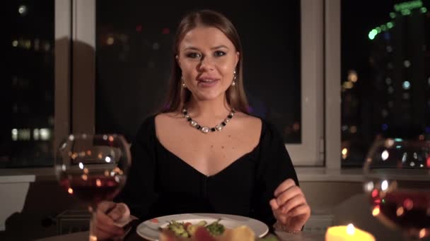 POV portrait of a woman being presented with a gift during a romantic dinner at home at night by candlelight. concept for celebration of valentines day, anniversary — Stok video