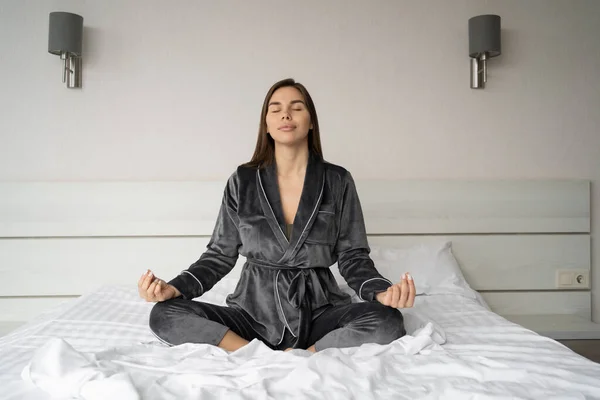 Portrait Long Haired Brunette Pajamas Meditating Sitting Soft Bed Morning — стоковое фото
