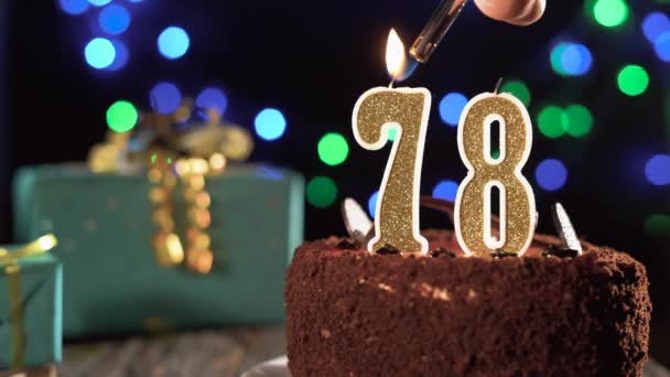 Number seventy-eight birthday candle on a sweet cake on the table, 78th birthday. Fire from the lighter, blow out the holiday candle. — Stock Video