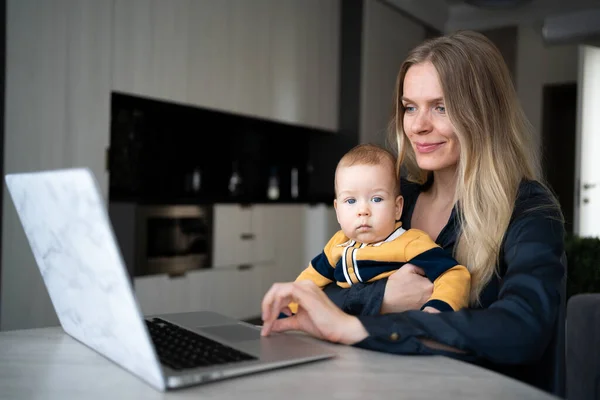 businesswoman mother woman working with baby at laptop, remote work at home young mother with child, people and technology concept