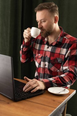 Yakışıklı erkek tasarımcı kafeterya kahvesi içiyor ve dizüstü bilgisayarla yeni bir proje üzerinde çalışıyor, milenyum öğrencisi internette kahve molası veriyor, iş adamı evlerinin önünde günlük kıyafetlerini giyiyor.