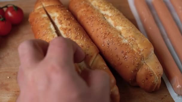 Hot dog cooking process, fast food, american snack, chefs hands preparing delicious fresh hot dog with ketchup — Stock Video
