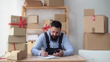 small business concept, indian entrepreneur business owner taking online order using smart phone working in home office or warehouse, sme, delivery shipping, business start-up