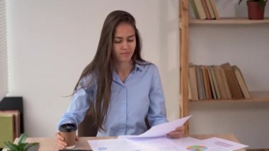 office work with paper documents, latin businesswoman working at home, reading employee financial report, business project