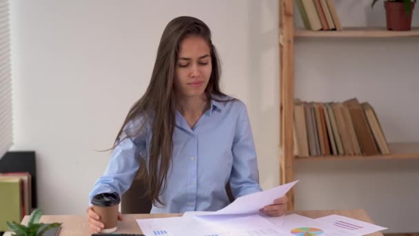 Office work with paper documents, latin businesswoman working at home, reading employee financial report, business project — Stockvideo