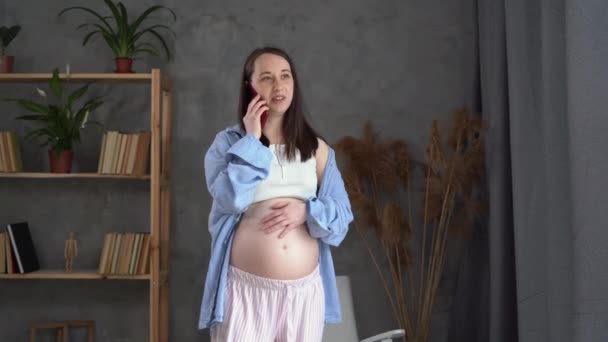 Pregnant woman back pain, pregnancy discomfort call to the doctor, expectant mothers lower back massage, health and pregnancy — Vídeo de Stock